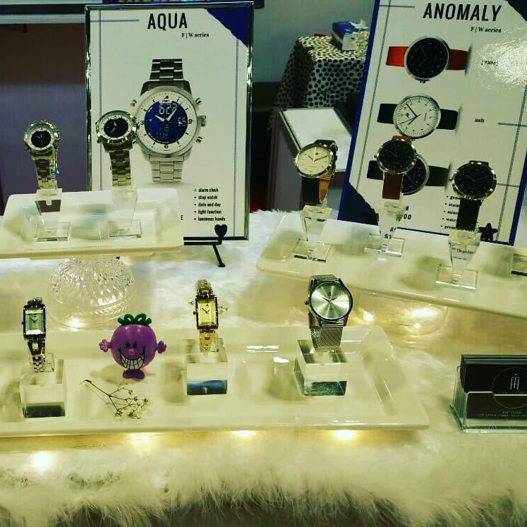 A retail display showcasing a variety of stylish watches from the Aqua and Anomaly series.
