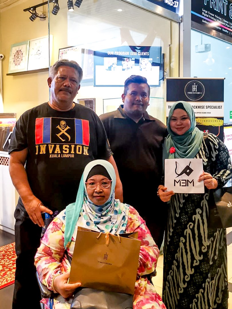 Customers pose with branded items inside Time To Hijra, a shop offering specialized services.