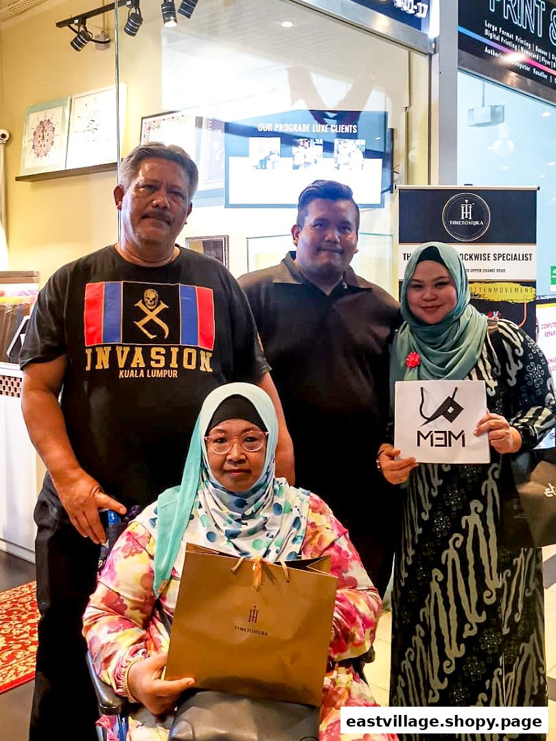 Customers pose with branded items inside Time To Hijra, a shop offering specialized services.