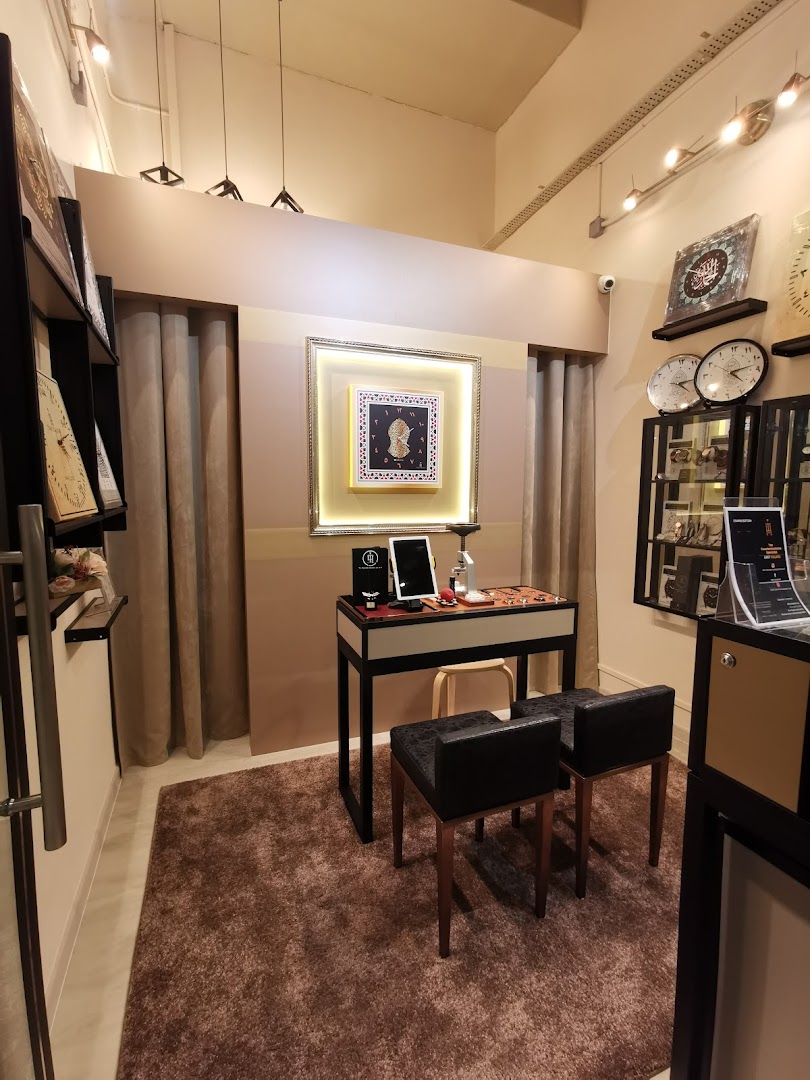 An elegant interior view of 'Time To Hijra' showcasing unique clocks and Islamic art pieces.
