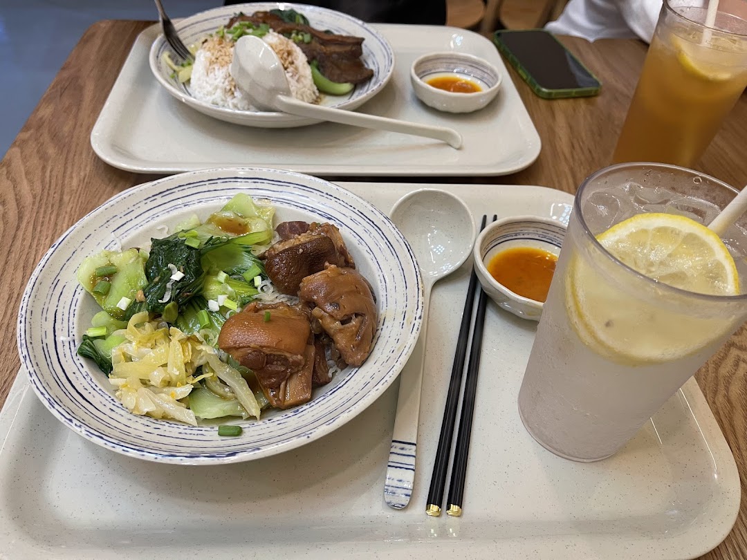 Two delicious traditional Chinese meals featuring braised meats, vegetables, and refreshing drinks served on trays.