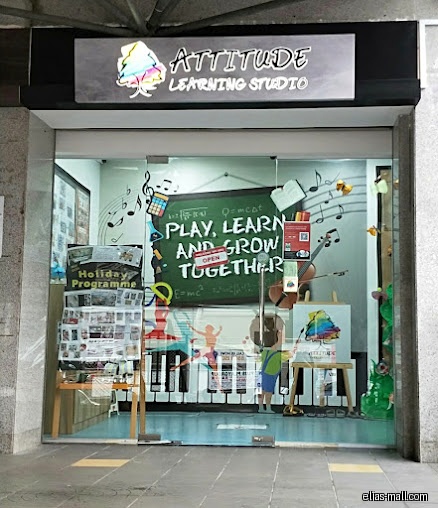 Attitude Learning Studio's storefront with colorful window decorations and program information.