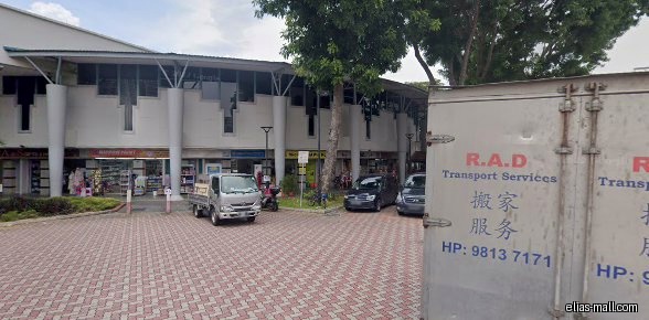 The image shows the exterior of a row of shops, including AXS Station.