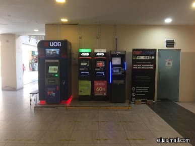 The image shows several ATMs, including AXS machines, in a mall setting.