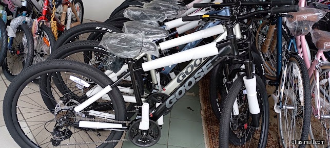 The image shows a selection of new bicycles inside a shop.