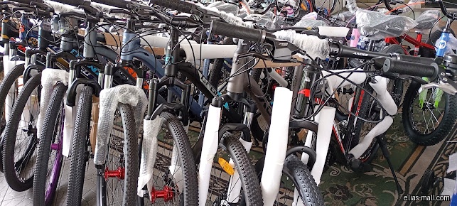 The image shows a selection of bicycles inside the Bike World shop.