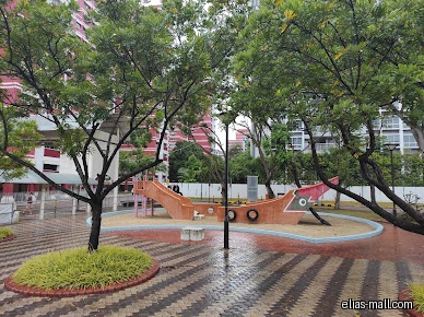 The image shows a playground with a boat-shaped structure and trees.