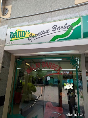 Daud.s Creative Barber shop front with glass doors and a sign.