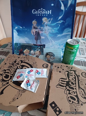 Two Domino's pizza boxes, a Genshin Impact bag, and a soda can.