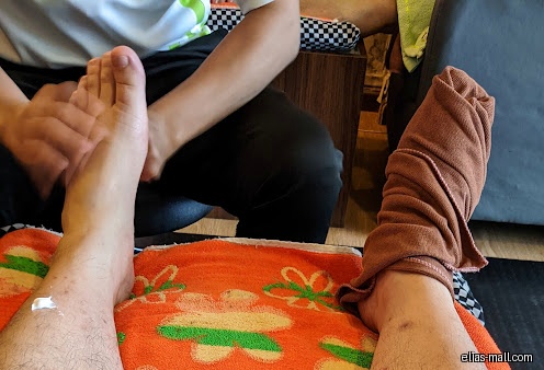 A person receiving a foot massage at Donglin Foot Reflexology.