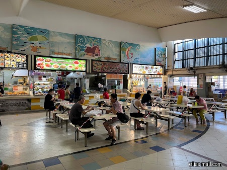 Elias Mall food court with people eating at tables and food stalls.