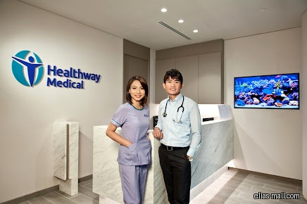 Healthway Medical reception area with two staff members and logo.