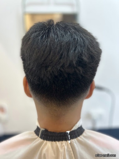 Close-up of a person's head showing a fresh haircut at IZ Hair Studio.
