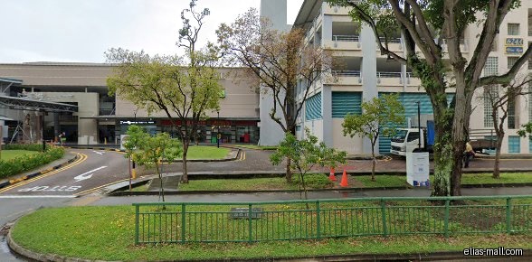The image shows the exterior of a building with shops.