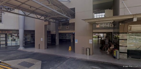 Exterior view of a building with shops, including L & G medical Clinic.