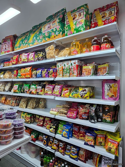 Shelves stocked with various snacks, chips, and other food items in a store.