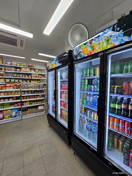 Interior view of MH Convenience Store with shelves and drink refrigerators.