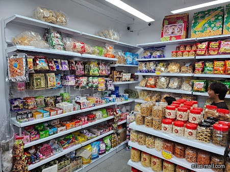 Interior shot of MH Convenience Store with shelves stocked with snacks and treats.