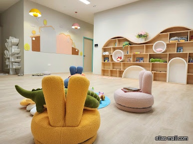 Interior of Out Of Box Academy - Elias with shelves and children's furniture.