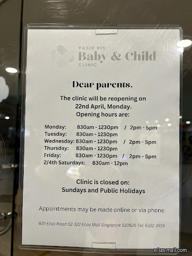 A sign displays the opening hours for Pasir Ris Baby & Child Clinic.
