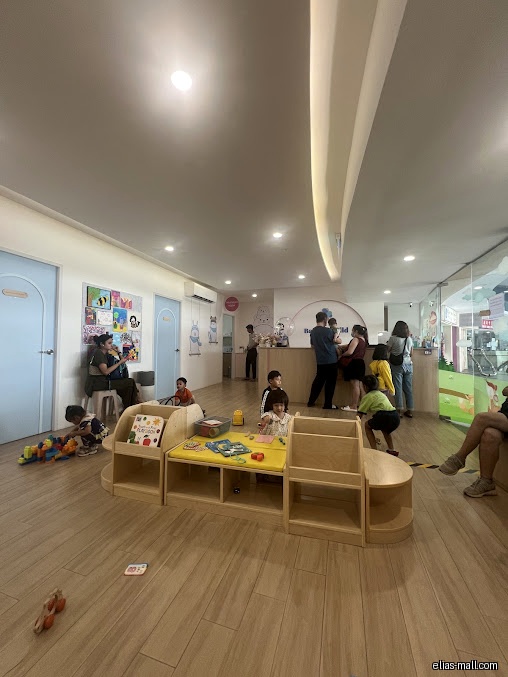 The image shows the interior of Pasir Ris Baby & Child Clinic's waiting area.