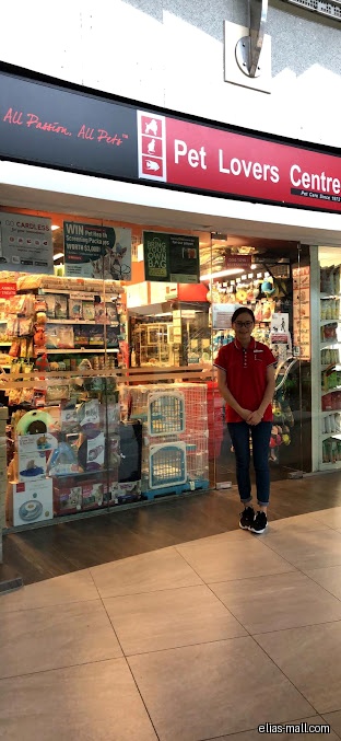 The Pet Lovers Centre shop front with a staff member standing outside.