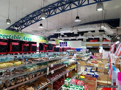 Interior view of Sheng Siong Supermarket, showing produce and shopping carts.