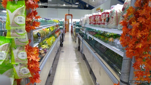 Aisles of produce are displayed in a Sheng Siong Supermarket.