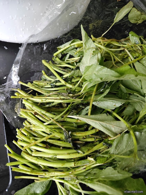 A close-up shot of a bunch of green leafy vegetables.