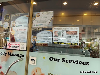 Shop front with certificates and service price list on the glass door.