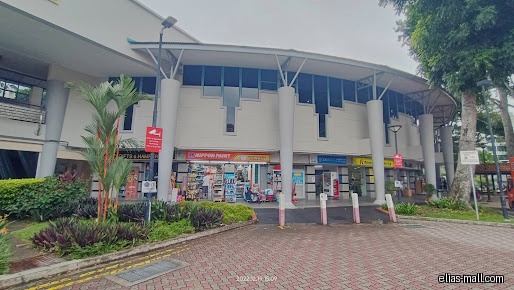 The image shows the exterior of several shops in a commercial building.