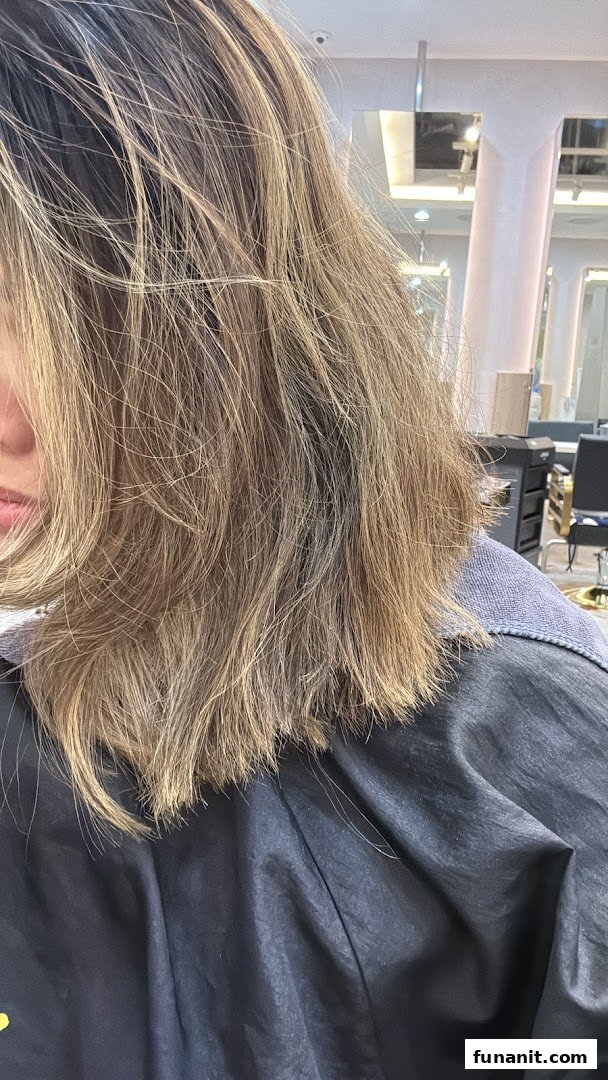 Close-up of a person's styled hair, showcasing a fresh look from the salon.