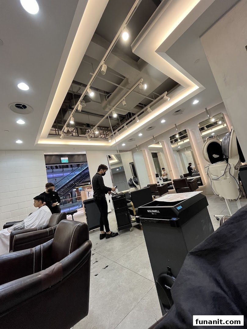 Interior view of a modern hair salon with stylists attending to customers.