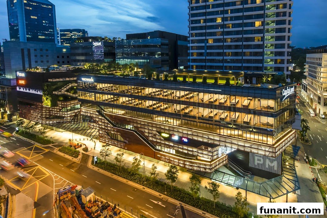 An illuminated aerial view of Funan mall's modern exterior at dusk.