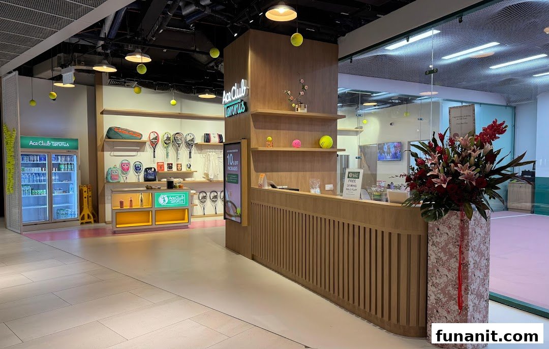 Interior view of Ace Club Tennis, showcasing merchandise displays, a reception desk, and a tennis court.