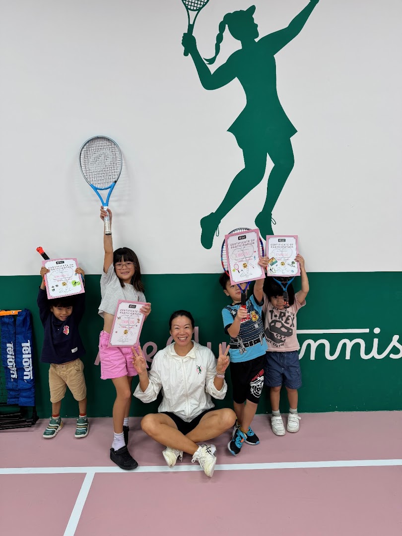 An instructor and children proudly display participation certificates at Ace Club Tennis.