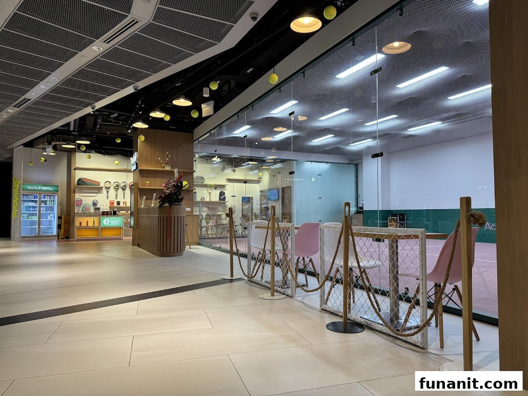 Entrance and retail area of Ace Club Tennis, featuring a view into a tennis court.