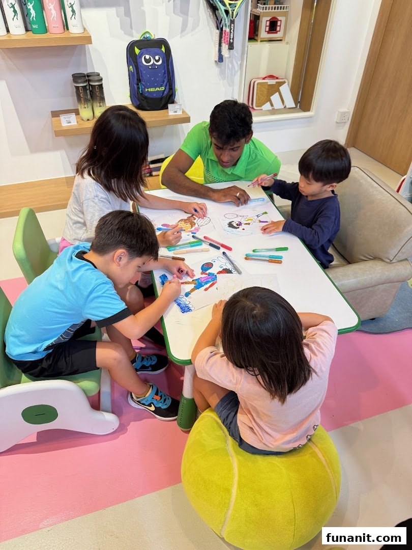 Children and an adult coloring at a table in a tennis-themed shop interior.