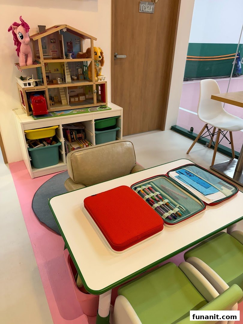 A vibrant children's play area with a dollhouse and activity table, adjacent to a tennis court.