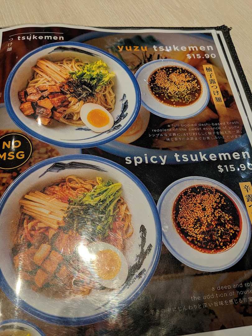 A close-up of Afuri's menu, showcasing their Yuzu Tsukemen and Spicy Tsukemen dishes with prices and descriptions.