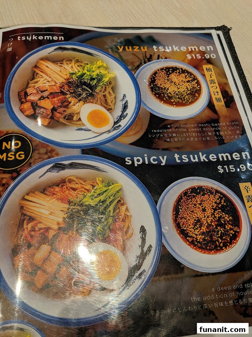 A close-up of Afuri's menu, showcasing their Yuzu Tsukemen and Spicy Tsukemen dishes with prices and descriptions.