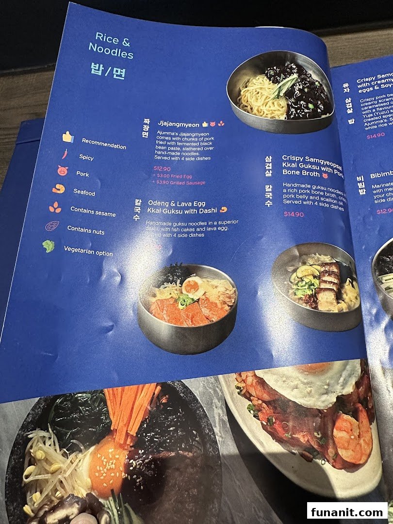 A detailed menu page from Ajummas, showcasing various Korean noodle and rice dishes with descriptions and prices.