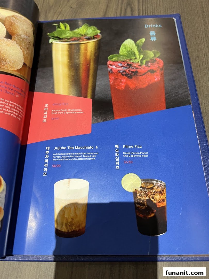 A menu page from Ajummas displaying various Korean-inspired drinks with descriptions and prices.