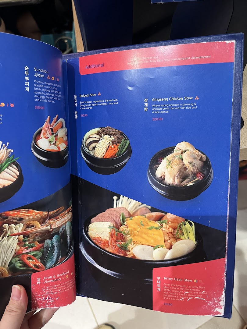 A vibrant menu page from Ajummas, showcasing various Korean stews with descriptions and prices.