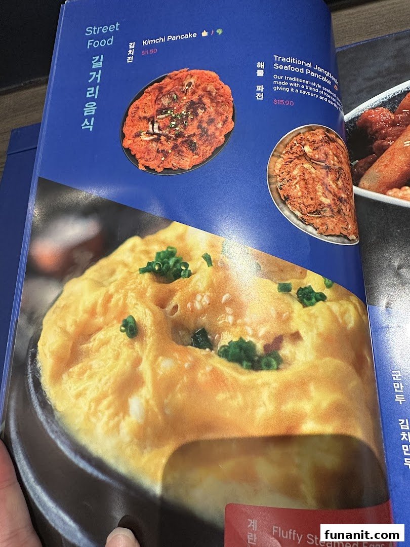A close-up of a Korean restaurant menu featuring savory pancakes and fluffy steamed eggs.