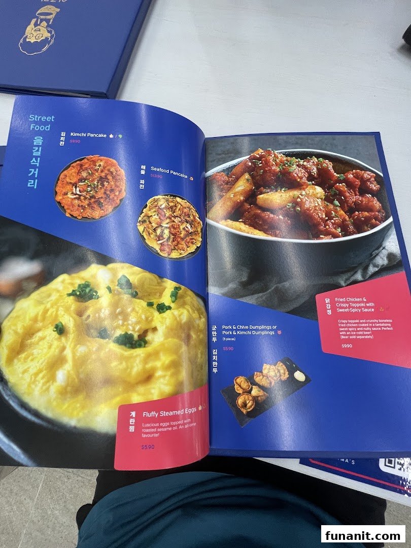 A vibrant menu from Ajummas showcasing popular Korean street food dishes.