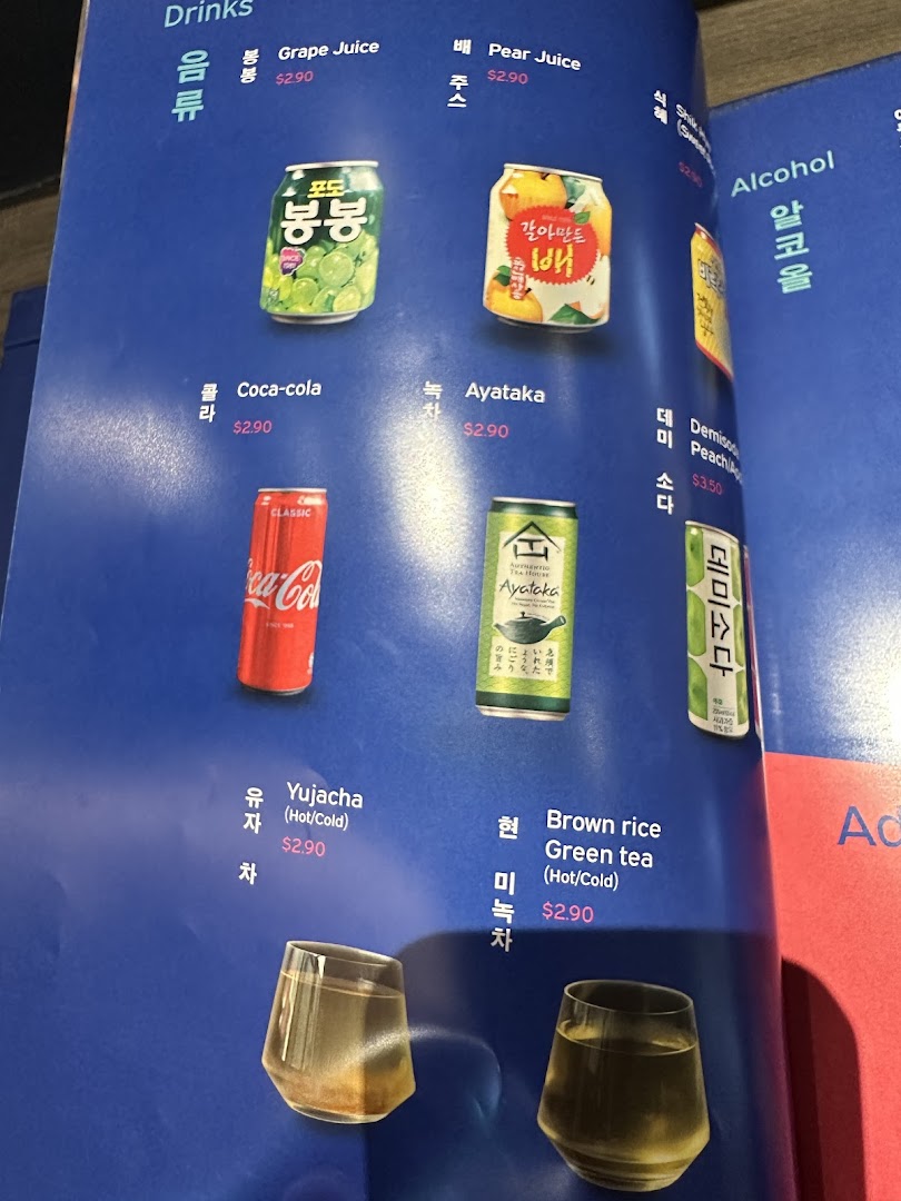 A close-up view of a drinks menu featuring various beverages and their prices.