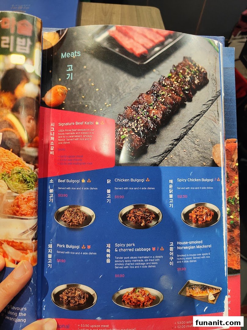 A detailed menu page from Ajummas, showcasing various Korean meat dishes with descriptions and prices.