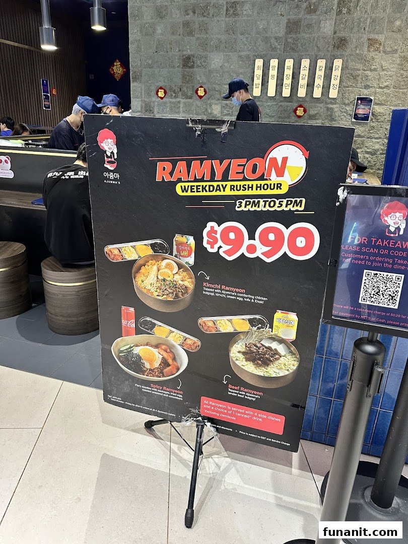 A promotional menu board for Ajummas, featuring Ramyeon dishes and a weekday rush hour special.