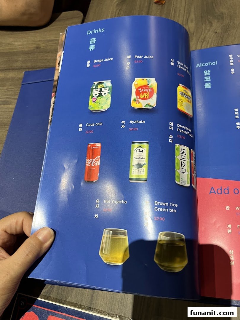 A close-up of a blue menu page displaying various Korean drinks and their prices.